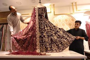 Vendors displaying bridal dresses for sell at thier shop to attract the customers at Cantt Bazar