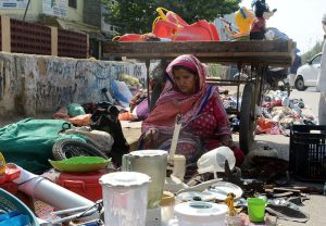 A woman vendor sells used household items at his roadside setup in the Provincial Capital.