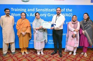 Project Officer UNDP Pakistan, Ejaz Khan, along with former Ombudsperson KP, Ms. Rakshanda Naz, gives a certificate to Chairperson KPCSW, Sumaira Shams, during a training and sensitization session of the Women’s Advisory Group (WAG) at a local hotel.