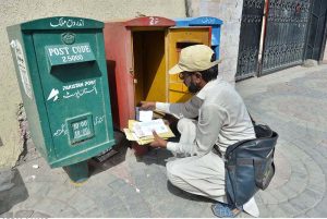 A postman is collecting letters from a post box in front of GPO as the world celebrates World Post Day on October 9.