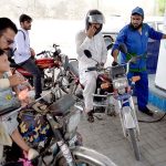 Petrol pump worker serves a customer as the government announces decrease in petrol prices by PKR 5.66 per litter