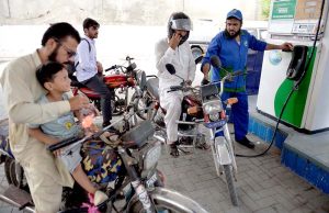 Petrol pump worker serves a customer as the government announces decrease in petrol prices by PKR 5.66 per litter