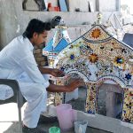 An artist creates mosaic mirror patterns work on a mosque arch a traditional art form for which Bahawalpur and Multan are renowned