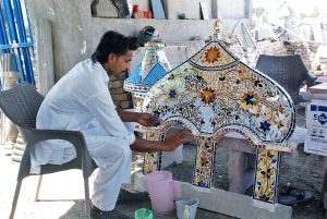 An artist creates mosaic mirror patterns work on a mosque arch a traditional art form for which Bahawalpur and Multan are renowned