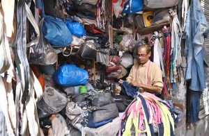 A tailor busy repairing zippers of bags at his setup in Qala Gujjar Singh.