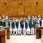 A group photograph of the students and faculty members from Dare-e-Arqam Schools, Abbottabad in the Senate hall at Parliament House