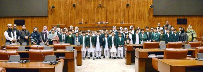 A group photograph of the students and faculty members from Dare-e-Arqam Schools, Abbottabad in the Senate hall at Parliament House