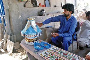 An artist creates mosaic mirror patterns work on a mosque arch a traditional art form for which Bahawalpur and Multan are renowned