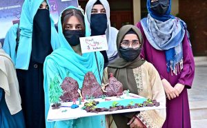 Students of Government College Women University Faisalabad (GCWUF) participate in a walk organized to mark Kashmir Black Day at the university campus.