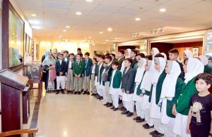 A group photograph of the students and faculty members from Dare-e-Arqam Schools, Abbottabad in the Senate hall at Parliament House