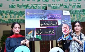 Students of Government College Women University Faisalabad (GCWUF) participate in a walk organized to mark Kashmir Black Day at the university campus.