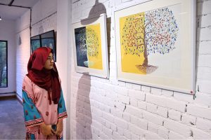 Women viewing the exhibition “Tree for Life”, a solo show by Farrah Mahmood, at FMR Art & Culture Gallery