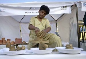 Stall holders decorate flowers during the Islamabad Sheher Mela, which is celebrating the 65th Anniversary of Islamabad’s Master Plan in connection with World Cities Day at F-9 Park.