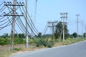 Electric wires hang dangerously low from poles along Millat Road, posing a serious risk of accidents