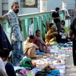 Vendors occupy the overhead pedestrian bridge, causing hardship for people