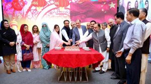 Chief Secretary KP Shahab Ali Shah and China Window Administrator Amjad Aziz Malik along with other officials cutting cake to mark the 76th Anniversary of the Republic of China organized by China Window.