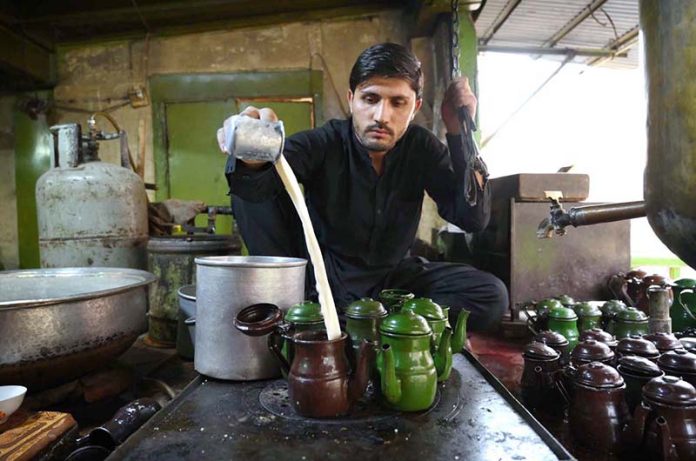 A worker prepares the famous Qehwa and tea at a shop in Qissa Khwani Bazaar, one of the oldest markets in South Asia, where traditional food shops, hotels, and Qehwa Khanas attract a large number of visitors