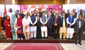 Chief Secretary KP Shahab Ali Shah and China Window Administrator Amjad Aziz Malik along with other officials cutting cake to mark the 76th Anniversary of the Republic of China organized by China Window.