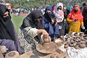A student making clay pot on stall during Zarai Mela at University of Agriculture Faisalabad (UAF)