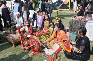 A student making clay pot on stall during Zarai Mela at University of Agriculture Faisalabad (UAF)