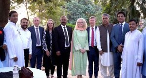 Senator Khalil Tahir Sandhu in a group photo with foreign dignitaries during a relief goods distribution ceremony in Sialkot.