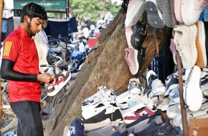A youngster buying shoes in anticipation of the upcoming winter season.