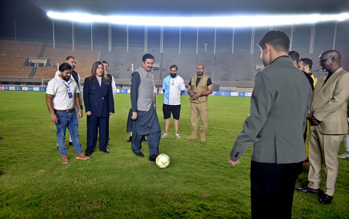 Governor Khyber Pakhtunkhwa, Faisal Karim Kundi, kicking a football to inaugurate the Dream Fest 2025 event at Jinnah Stadium, Sports Complex