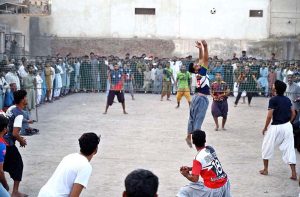 Youngsters playing Volleyball game near PCB Cricket Ground Shaikh Zaid Colony.