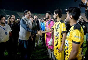 Governor Khyber Pakhtunkhwa, Faisal Karim Kundi, kicking a football to inaugurate the Dream Fest 2025 event at Jinnah Stadium, Sports Complex