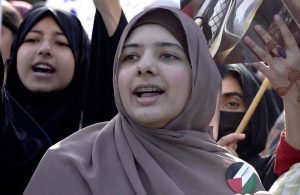 A female member of the Sunni Ulema Council, carrying her child, joins a protest outside the National Press Club against the Israeli attack on an aid convoy for Palestinians and the arrest of former Senator Mushtaq Ahmed along with members of the International Sumud Flotilla.