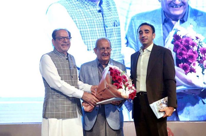President Arts Council of Pakistan, Muhammad Ahmed Shad along with Chairman of Pakistan People’s Party (PPP) Bilawal Bhutto Zardari presenting a bouquet of flower to PPP leader Mian Raza Rabbani at the Dedication Ceremony of Book titled 'The Smile Snatchers' by PPP leader Main Raza Rabbani at Arts Council of Pakistan