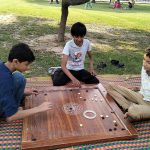 Youngsters playing carom board during the sports competitions organized by the Walled City of Lahore Authority at Shalimar Bagh