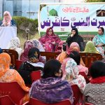 A women reciting Naat during the Seerat ul Nabi Conference at the Gomi Bai Ladies Club