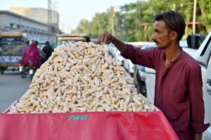 A vendor is displaying sweet food item to attract the customers at Royal Road