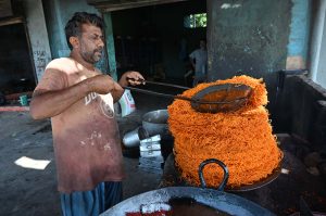 A vendor is displaying sweet food item to attract the customers at Royal Road