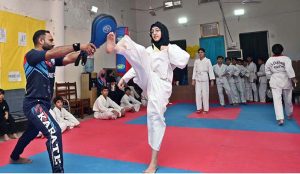 Marshal art young student demonstrate her skills during the Karate Academy Belt Promotion ceremony at the University of Sargodha.