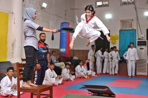 Marshal art young student demonstrate her skills during the Karate Academy Belt Promotion ceremony at the University of Sargodha.