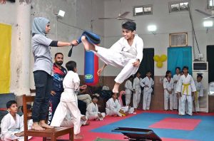 Marshal art young student demonstrate her skills during the Karate Academy Belt Promotion ceremony at the University of Sargodha.