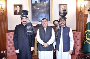 Chairman Pakistan Red Crescent Khyber Pakhtunkhwa, Farzand Ali Wazir presenting a traditional turban to Acting President Syed Yousuf Raza Gilani at Governor House.