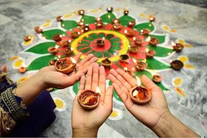 Girls from the Hindu community lighting lamps during the Diwali festival at Durga Shiv Mandir in GOR Colony.