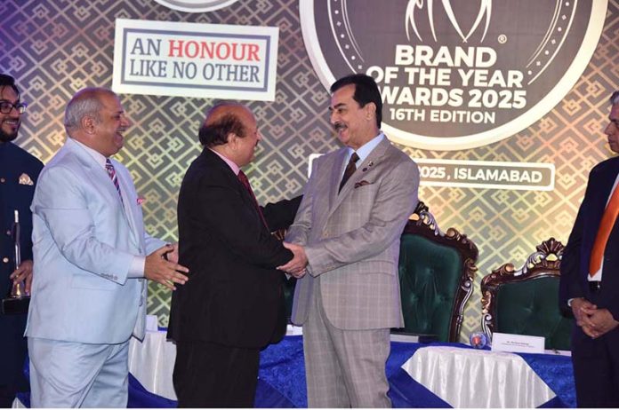 Chairman Senate, Syed Yousaf Raza Gilani shaking hands with Lord Qurban Hussain, Member of the house of Lords at the award distribution ceremony 16th edition of 