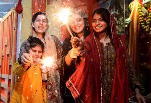 Girls from the Hindu community lighting lamps during the Diwali festival at Durga Shiv Mandir in GOR Colony.