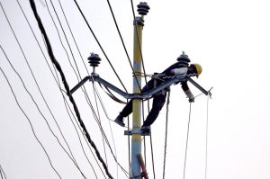 Workers of private company installing the high Tension Electric wire in the city.