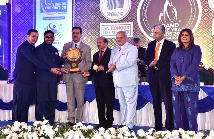 A souvenir is being presented to Chairman Senate, Syed Yousaf Raza Gilani by the organizer of the award distribution ceremony 16th edition of 