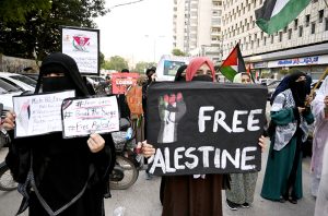 Women activists of Pakistan Palestine Forum chant slogans at a rally outside Karachi Press Club to protest against Israeli genocide in Gaza.