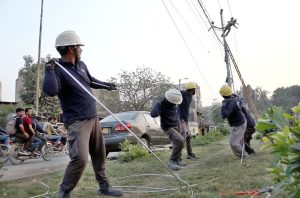 Workers of private company installing the high Tension Electric wire in the city.