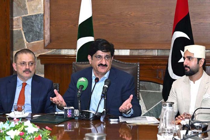 Sindh Chief Minister Syed Murad Ali Shah flanked by provincial ministers Sharjeel Memon and Sardar Muhammad Bux Mahar, addresses a press conference at CM House