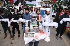 Women activists of Pakistan Palestine Forum chant slogans at a rally outside Karachi Press Club to protest against Israeli genocide in Gaza.