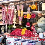 A vendor preparing flower garlands for customers at F-6 area in the Federal Capital