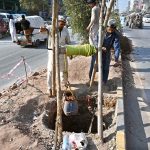 Labourers are busy digging a hole and removing soil to install an electric pole at Khana Pul